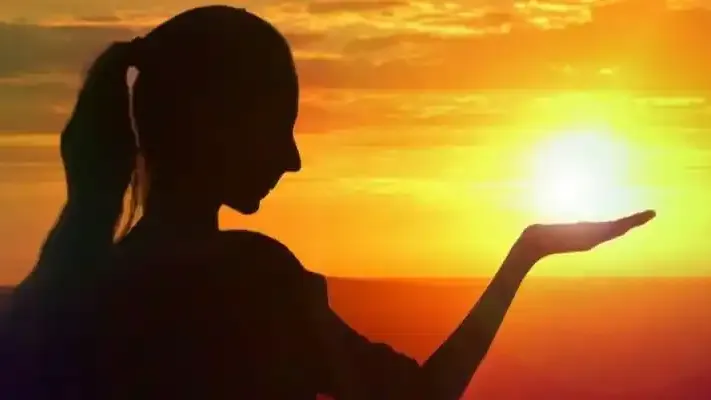 Woman holding sunset